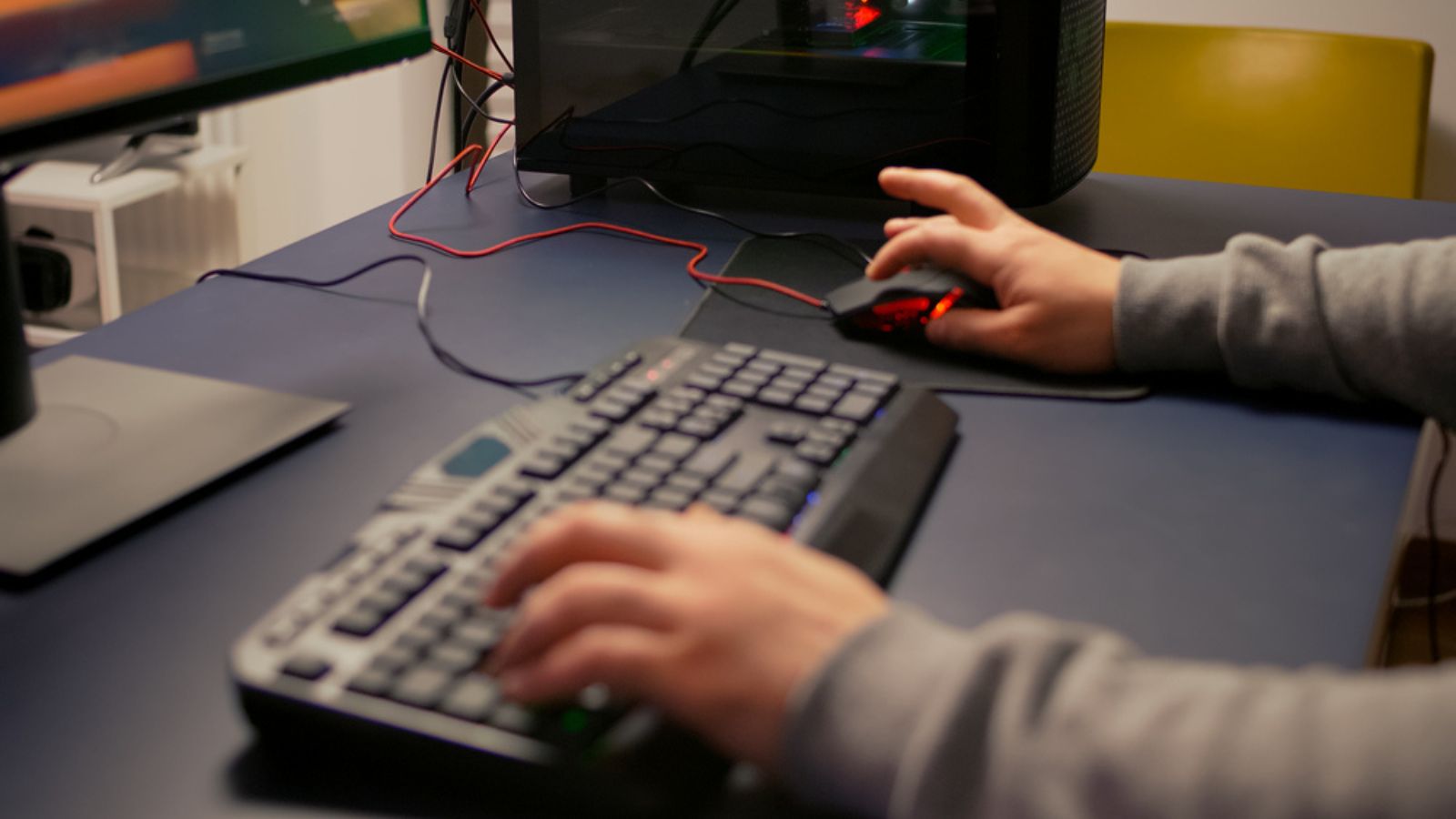 Closeup of player hands using RGB keyboard