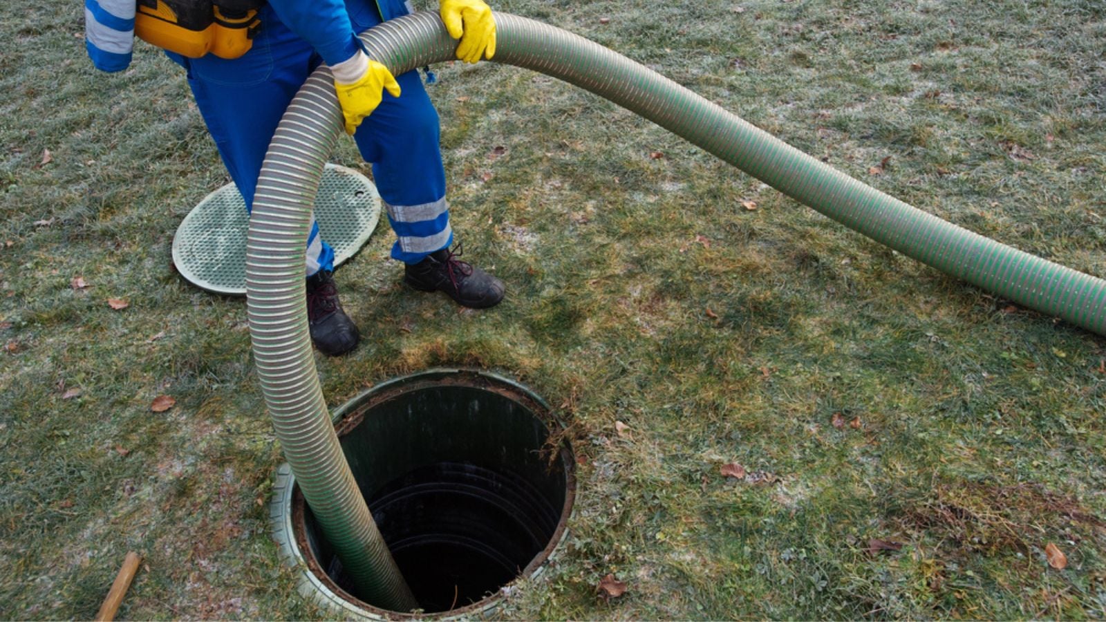 Emptying household septic tank. Cleaning sludge from septic system