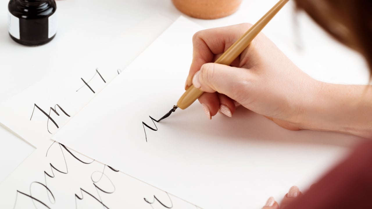 Girl writing calligraphy on postcards. Art design.