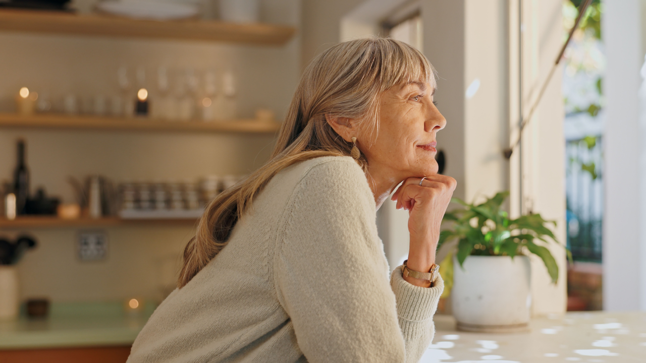 retired woman pensive thinking kitchen